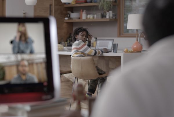 Virtual meeting with child in the background on a laptop computer